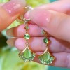 The light luxury and high-end green ginkgo leaf cat's eye stone long tassel earrings are fashionable and elegant, and are popular earrings for women The light luxury and high-end green ginkgo leaf cat's eye stone long tassel earrings are fashionable and elegant, and are popular earrings for women